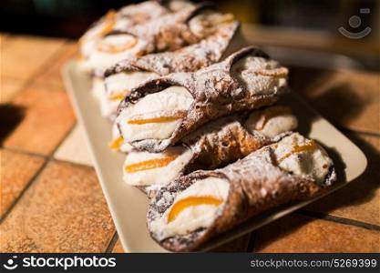 food, cooking and baking concept - pastry on plate at bakery. pastry on plate at bakery