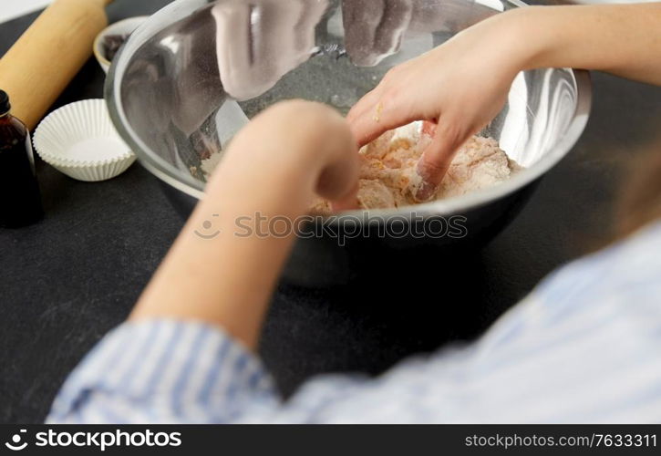 food cooking, baking and culinary concept - close up of hands making shortcrust pastry at bakery. close up of hands kneading dough at bakery