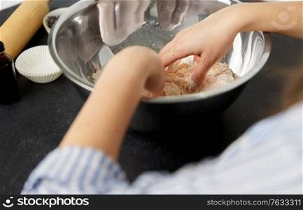 food cooking, baking and culinary concept - close up of hands making shortcrust pastry at bakery. close up of hands kneading dough at bakery