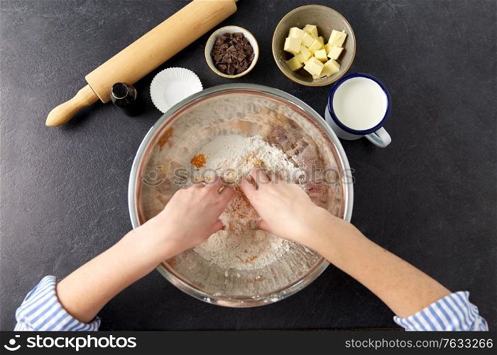 food cooking, baking and culinary concept - hands making shortcrust pastry at bakery. chef or baker making dough at bakery