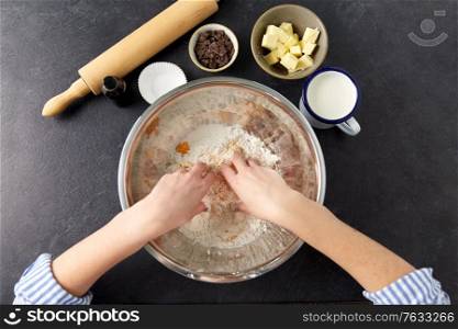 food cooking, baking and culinary concept - hands making shortcrust pastry at bakery. chef or baker making dough at bakery