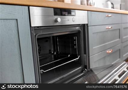 food cooking, culinary and home appliances concept - open oven at kitchen. open oven at home kitchen