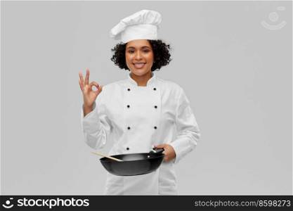 food cooking, culinary and people concept - happy smiling female chef with frying pan showing ok gesture over grey background. smiling female chef with frying pan showing ok