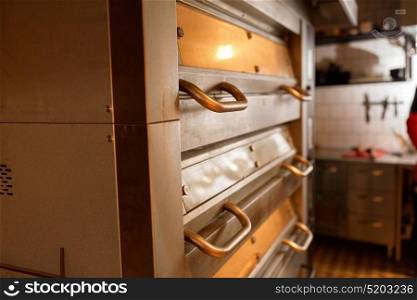 food cooking equipment and baking concept - bread oven at bakery kitchen. bread oven at bakery kitchen