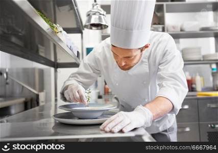 food cooking, profession and people concept - happy male chef cook serving plate of soup at restaurant kitchen. happy male chef cooking food at restaurant kitchen. happy male chef cooking food at restaurant kitchen