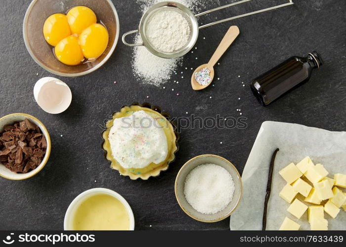 food, culinary and recipe concept - baking dish with dough and cooking ingredients on table. baking dish with dough and cooking ingredients