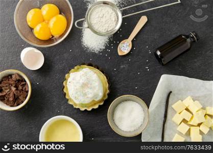 food, culinary and recipe concept - baking dish with dough and cooking ingredients on table. baking dish with dough and cooking ingredients