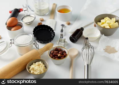 food, culinary and recipe concept - cooking ingredients and kitchen tools for baking on table. cooking ingredients and kitchen tools for baking