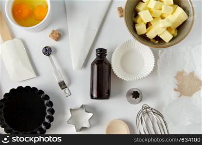 food, culinary and recipe concept - cooking ingredients and kitchen tools for baking on table. cooking ingredients and kitchen tools for baking
