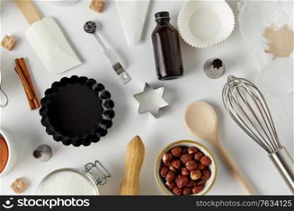 food, culinary and recipe concept - cooking ingredients and kitchen tools for baking on table. cooking ingredients and kitchen tools for baking