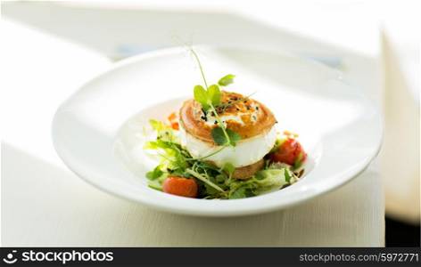 food, culinary, haute cuisine and cooking concept - close up of halloumi cheese salad with vegetables on plate at restaurant