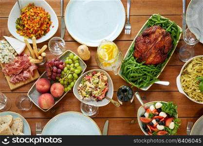 food, culinary, thanksgiving day and eating concept - various dishes on served wooden table from top. various food on served wooden table