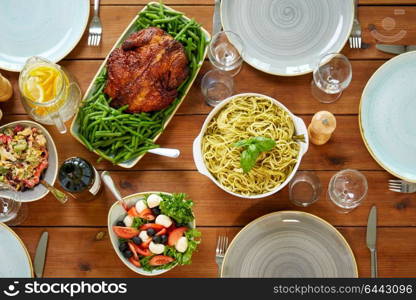 food, culinary, thanksgiving day and eating concept - various dishes on served wooden table from top. various food on served wooden table