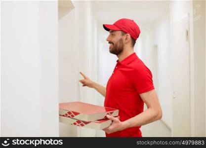 food delivery, mail and people concept - man delivering pizza in paper boxes to customer home and ringing doorbell. delivery man with pizza boxes ringing doorbell