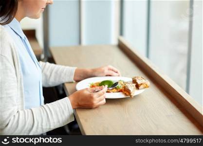 food, dinner, culinary and people concept - woman eating gazpacho soup with bread and spoon at restaurant