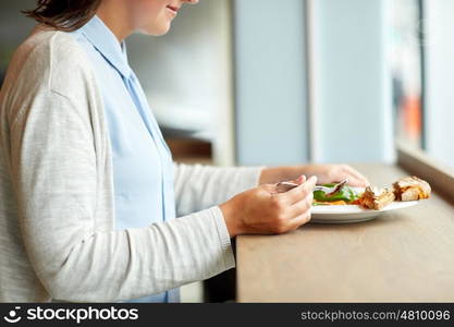 food, dinner, culinary and people concept - woman eating gazpacho soup with bread and spoon at restaurant