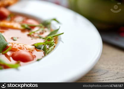 food, dinner, culinary, haute cuisine and cooking concept - close up of plate with delicious gazpacho soup at restaurant