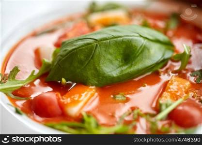food, dinner, culinary, haute cuisine and cooking concept - close up of plate with delicious gazpacho soup at restaurant