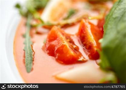 food, dinner, culinary, haute cuisine and cooking concept - close up of plate with delicious gazpacho soup at restaurant