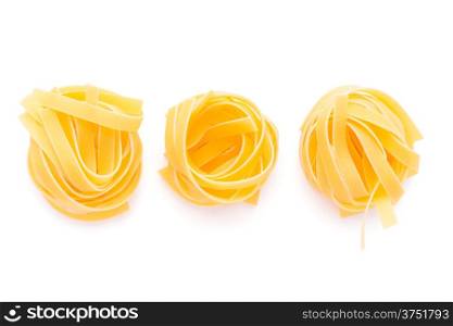 Food: dried italian pasta, fettuccine nests, isolated on white background