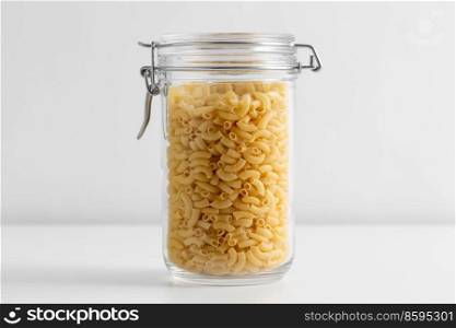 food, eating and cooking concept - jar with pasta on white background. close up of jar with pasta on white table