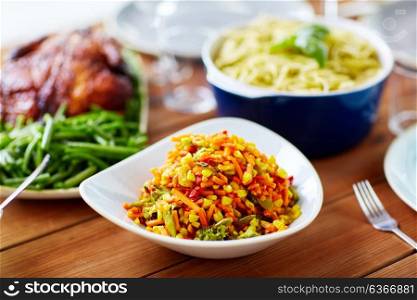food, eating and culinary concept - bowl of vegetable salad with corn on wooden table. vegetable salad with corn and other food on table