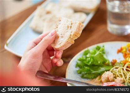 food, eating and people concept - hand of woman holding piece of bread. hand of woman holding piece of bread