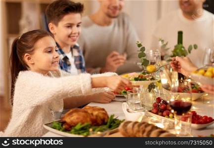 food, eating and people concept - happy family having dinner party at home. happy family having dinner party at home
