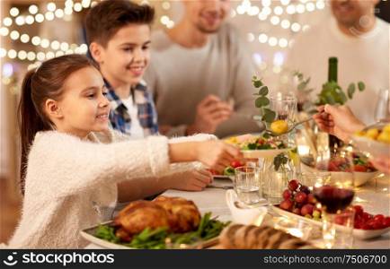 food, eating and people concept - happy family having dinner party at home. happy family having dinner party at home