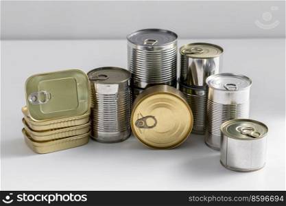 food, eating and preserve concept - close up of tin cans with preserves on table. close up of tin cans with preserved food on table