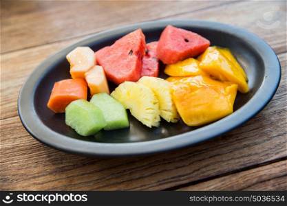 food, eco, bio and summer holidays concept - still life with exotic tropical fruits in bowl. still life with exotic tropical fruits in bowl