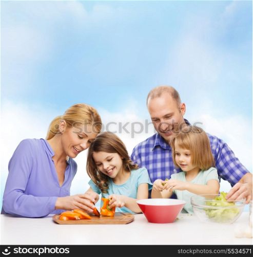 food, family, children, hapiness and people concept - happy family with two kids making dinner at home
