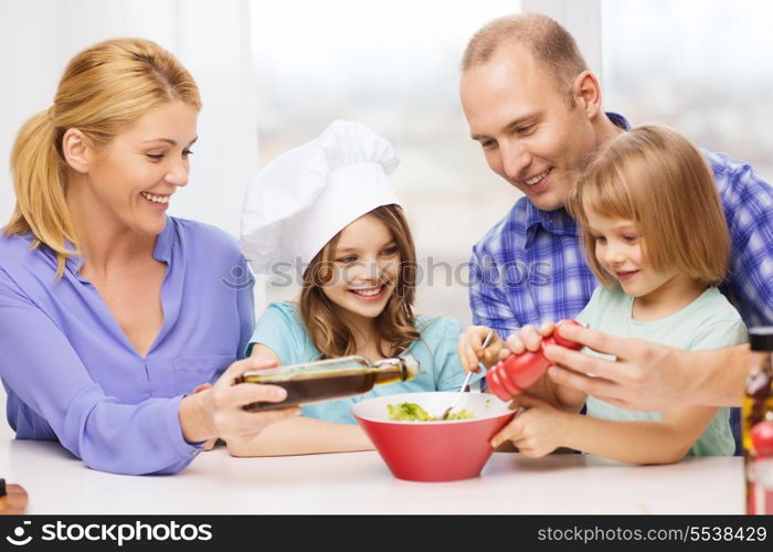 food, family, children, hapiness and people concept - happy family with two kids making dinner at home