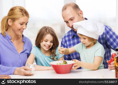 food, family, children, hapiness and people concept - happy family with two kids making dinner at home