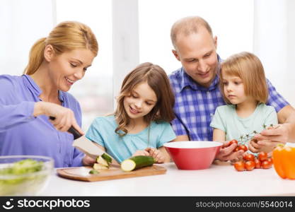 food, family, children, hapiness and people concept - happy family with two kids making dinner at home