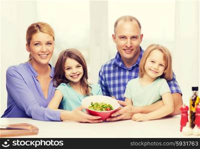 food, family, children, hapiness and people concept - happy family with two kids with salad at home