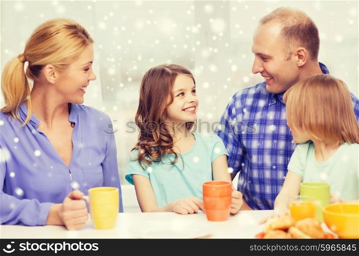 food, family, children, happiness and people concept - happy family with two kids having breakfast at home