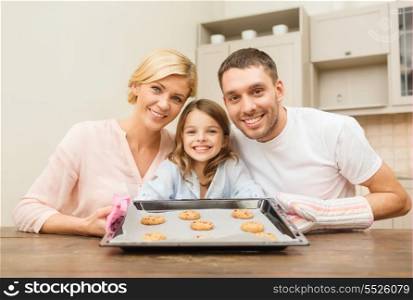 food, family, christmas, hapiness and people concept - happy family in making cookies at home