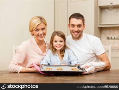 food, family, christmas, hapiness and people concept - happy family in making cookies at home