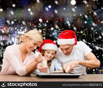 food, family, christmas, happiness and people concept - smiling family in santa helper hats with glaze and pan cooking over snowy night city background