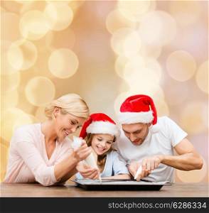 food, family, christmas, happiness and people concept - smiling family in santa helper hats with glaze and pan cooking over beige lights background