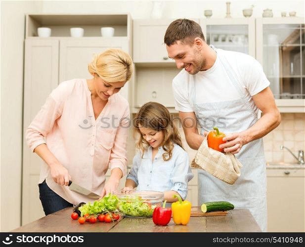 food, family, hapiness and people concept - happy family making dinner in kitchen