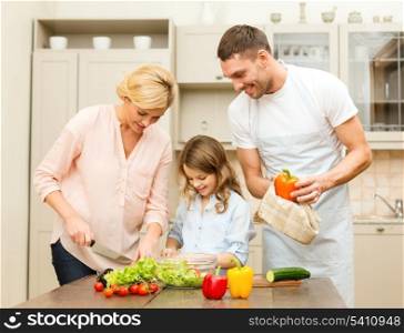 food, family, hapiness and people concept - happy family making dinner in kitchen