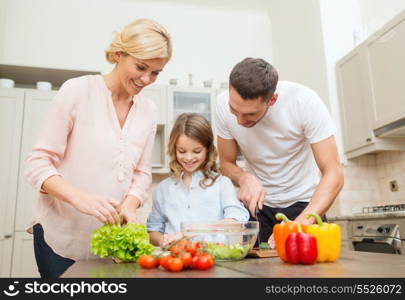 food, family, hapiness and people concept - happy family making dinner in kitchen