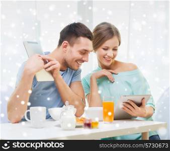 food, family, people and technology concept - smiling couple with tablet pc computers reading news and having breakfast at home