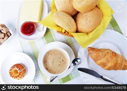 food for breakfast.coffee, buns, butter and jam