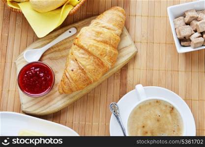 food for breakfast.coffee, croissant and jam