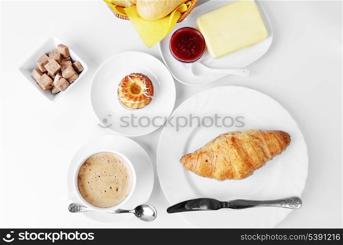 food for breakfast.coffee, croissant, butter and jam