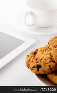Food: fresh homemade cookies, teacup and tablet, on white background