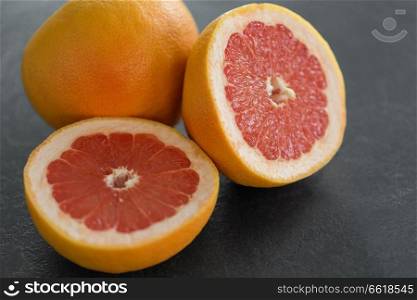 food, fruits and healthy eating concept - close up of fresh juicy grapefruits. close up of fresh juicy grapefruits